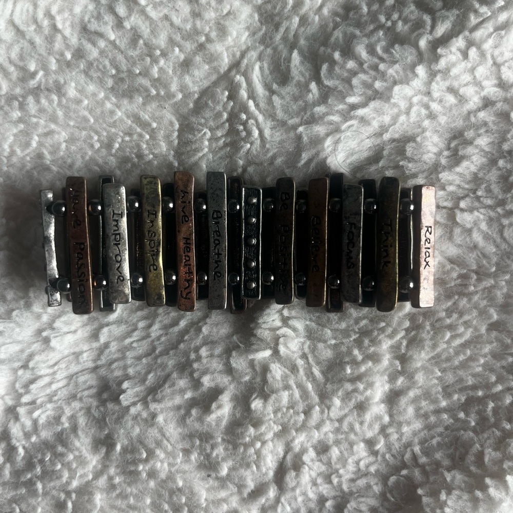 Bracelet. Stretchable multi colored metal w/inspirational words on bars